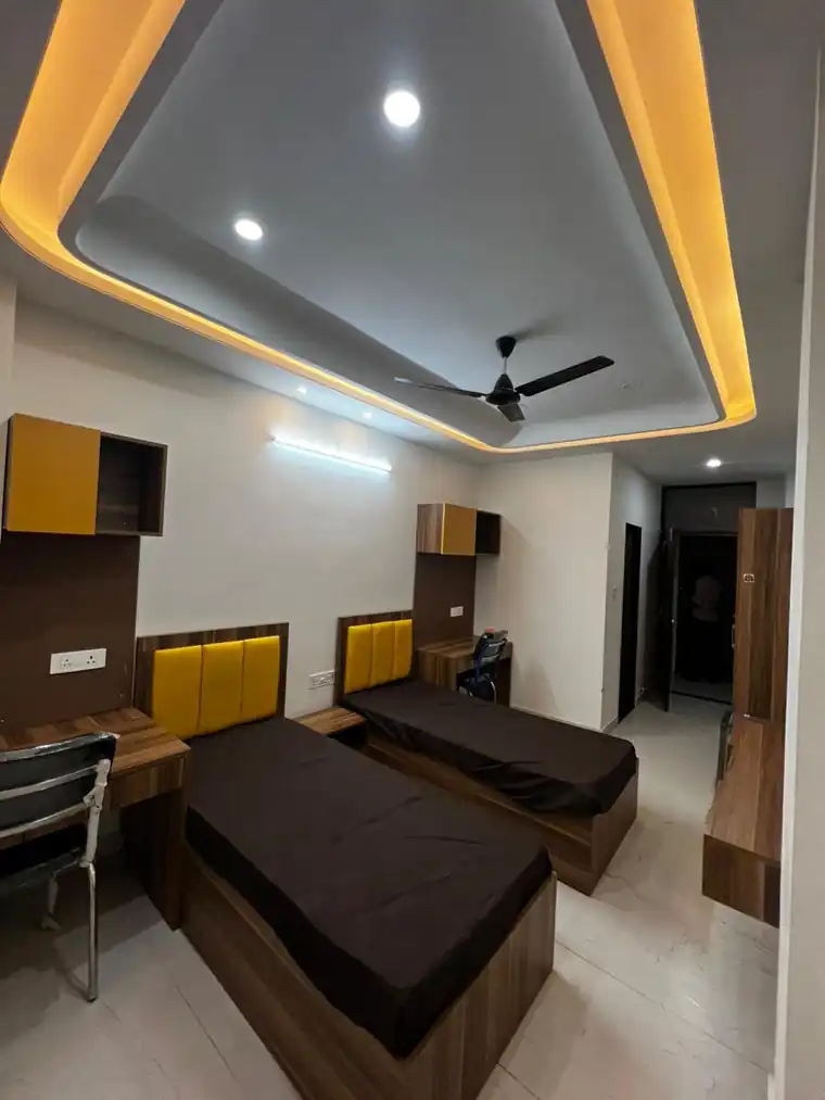 Bright student bedroom with twin beds and built-in storage
